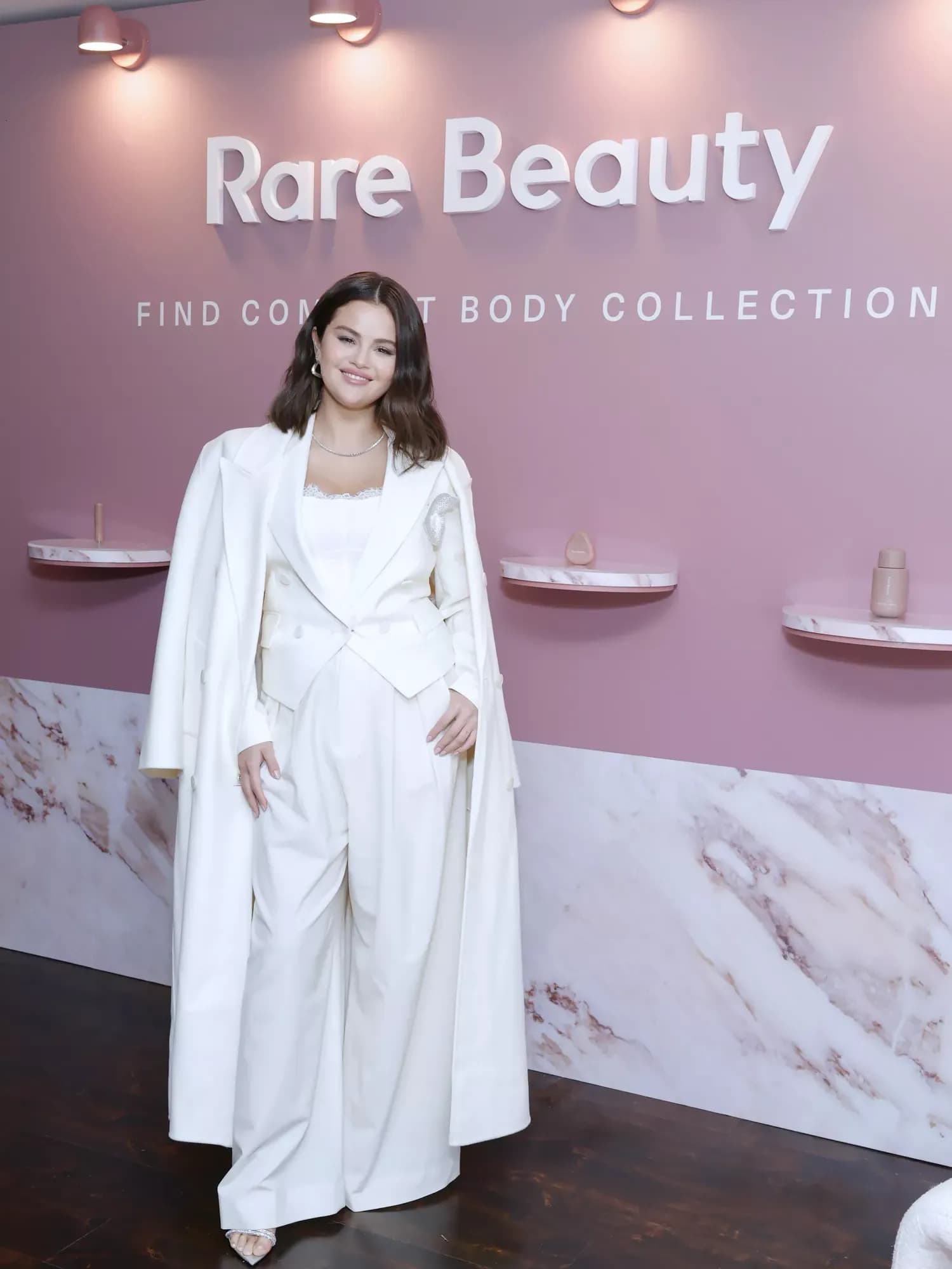 Selena Gomez Perfectly Embraces Winter Whites with a Lace Corset and Coordinated Pantsuit