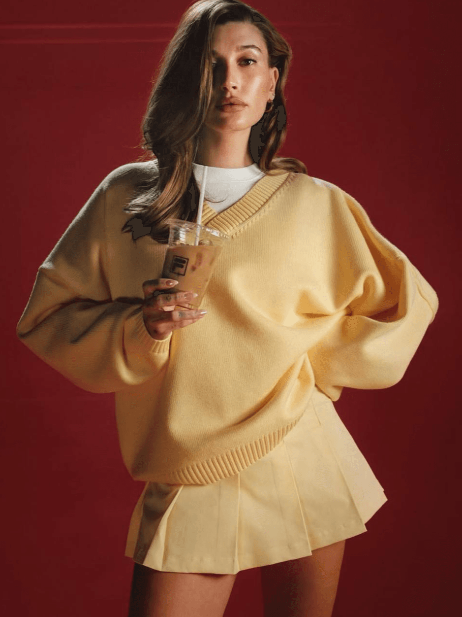 Hailey Bieber has reunited with FILA for the third time to launch a new Spring-Summer 2025 collection featuring 13 pieces, drawing inspiration from her personal style.
The collection emphasizes versatility, comfort, and functionality. “If I wouldn’t wear it, I wouldn’t put it out there,” Hailey shares about the line.
Reinterpreting FILA's classics through a contemporary lens, the collection showcases signature silhouettes such as cropped tees, baggy pants, sporty tops, as well as skirts, knitw