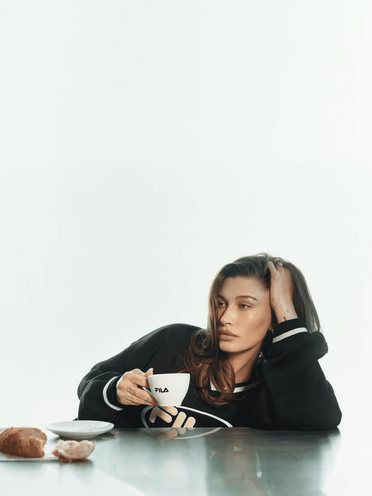 Hailey Bieber has reunited with FILA for the third time to launch a new Spring-Summer 2025 collection featuring 13 pieces, drawing inspiration from her personal style.
The collection emphasizes versatility, comfort, and functionality. “If I wouldn’t wear it, I wouldn’t put it out there,” Hailey shares about the line.
Reinterpreting FILA's classics through a contemporary lens, the collection showcases signature silhouettes such as cropped tees, baggy pants, sporty tops, as well as skirts, knitw