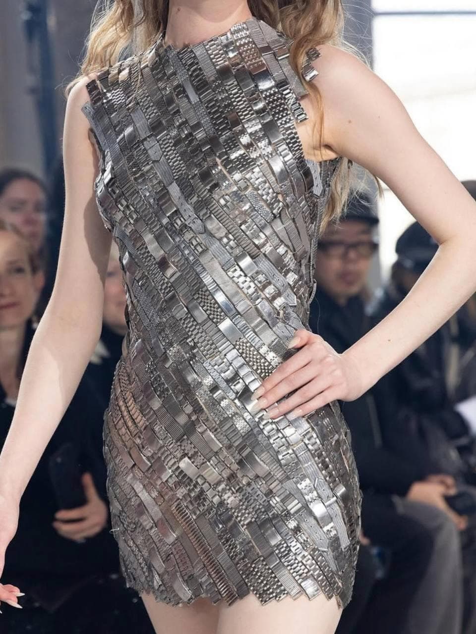 Marin Serr is a French designer renowned for her innovative approach to eco-friendly fashion, blending modernity with a unique retro aesthetic. She has gained recognition for utilizing recycled materials.
Her collections often feature a signature crescent motif, symbolizing her vision of a harmonious connection between style and sustainability.
One standout piece from her collection is a dress made from at least 150 stainless steel watch straps of various sizes and widths, intricately sewn tog