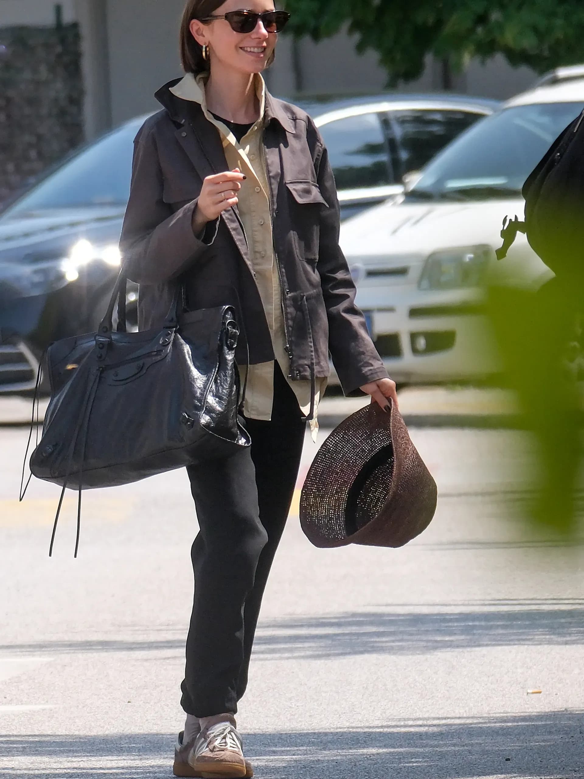 Lily Collins swaps a suitcase for a giant Balenciaga City bag in Venice, proving that oversized accessories make the best fashion statements.