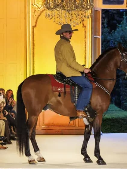 Post Malone unveils his Western-luxury label Austin Post in Paris, staging a cinematic runway with denim, suede, turquoise accents and a live horse.