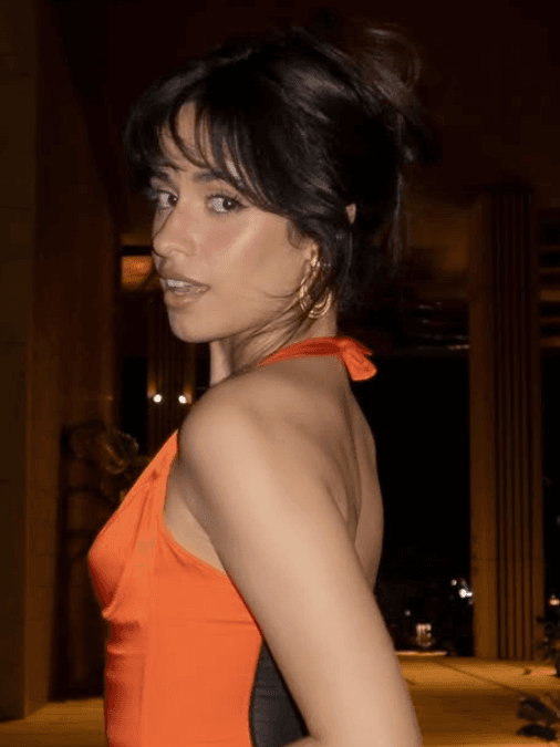 Camila Cabello stuns in a playful orange minidress, perfect for date night inspiration, fun, stylish photos, and standout fashion looks.